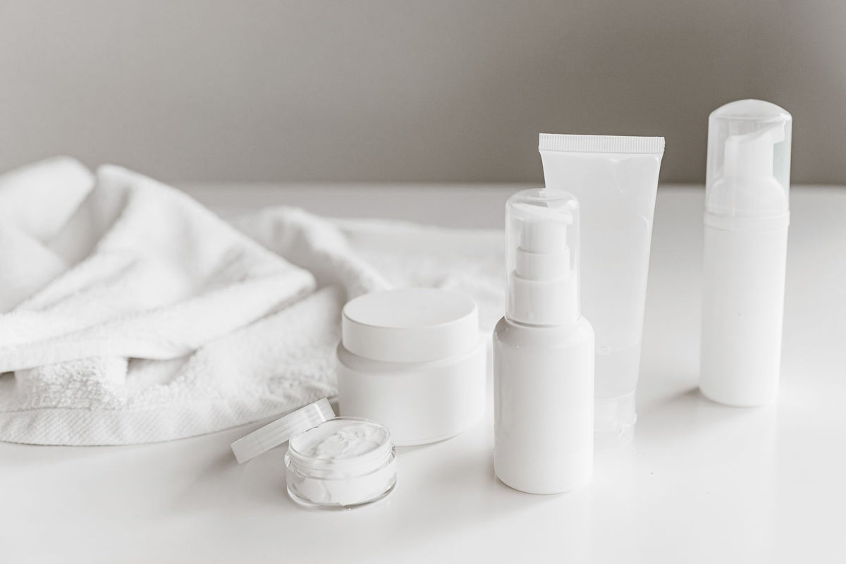 White skincare products on a light gray background