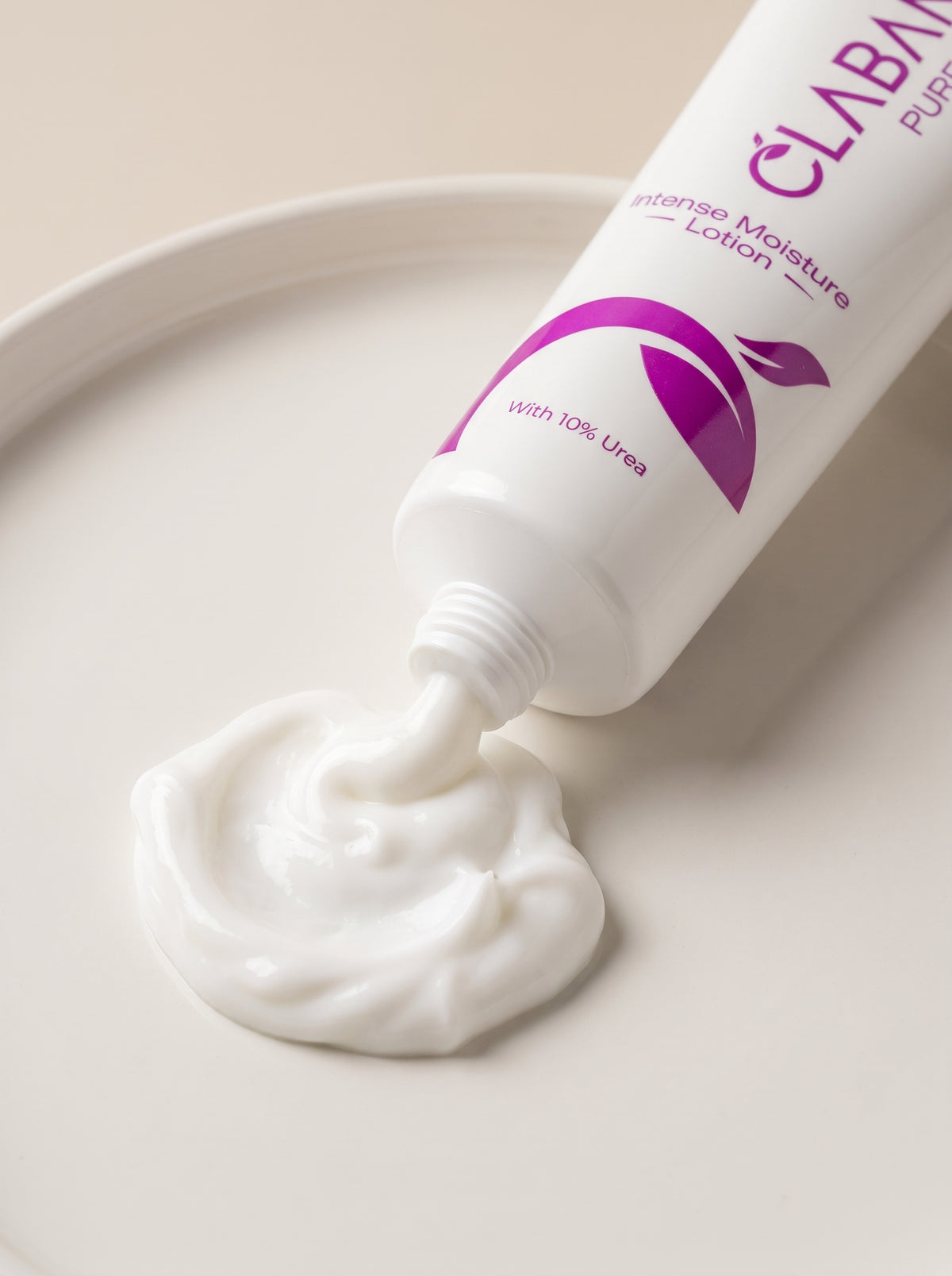 A white tube of CLABAN Purifying Intense Moisture Lotion with purple text and logo, shown dispensing thick white lotion onto a matching white surface.