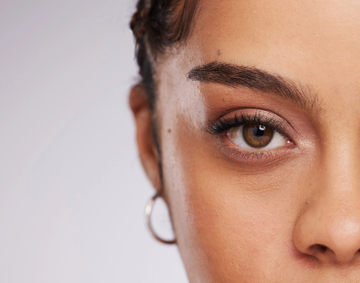 Close-up of a person's eye with a neutral background