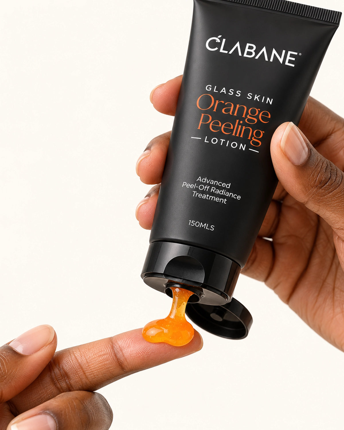A hand holds a black tube of Clabane Glass Skin Orange Peeling Lotion, with orange gel being squeezed onto another finger against a clean white background.